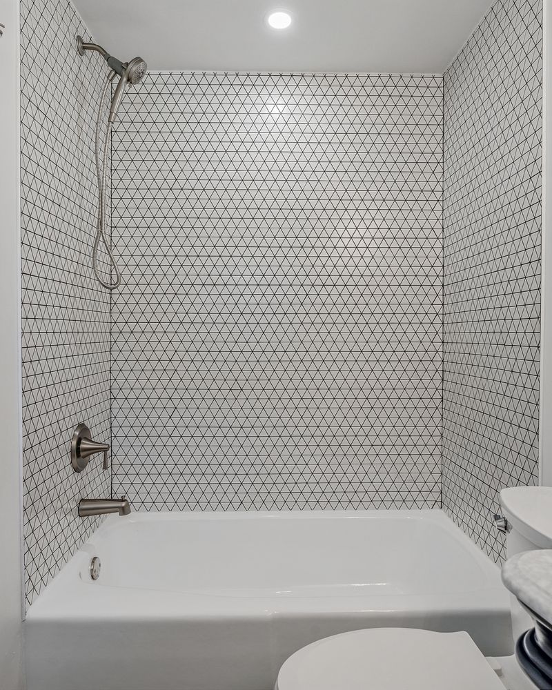 Tub and shower with white hexagon mosaic tile